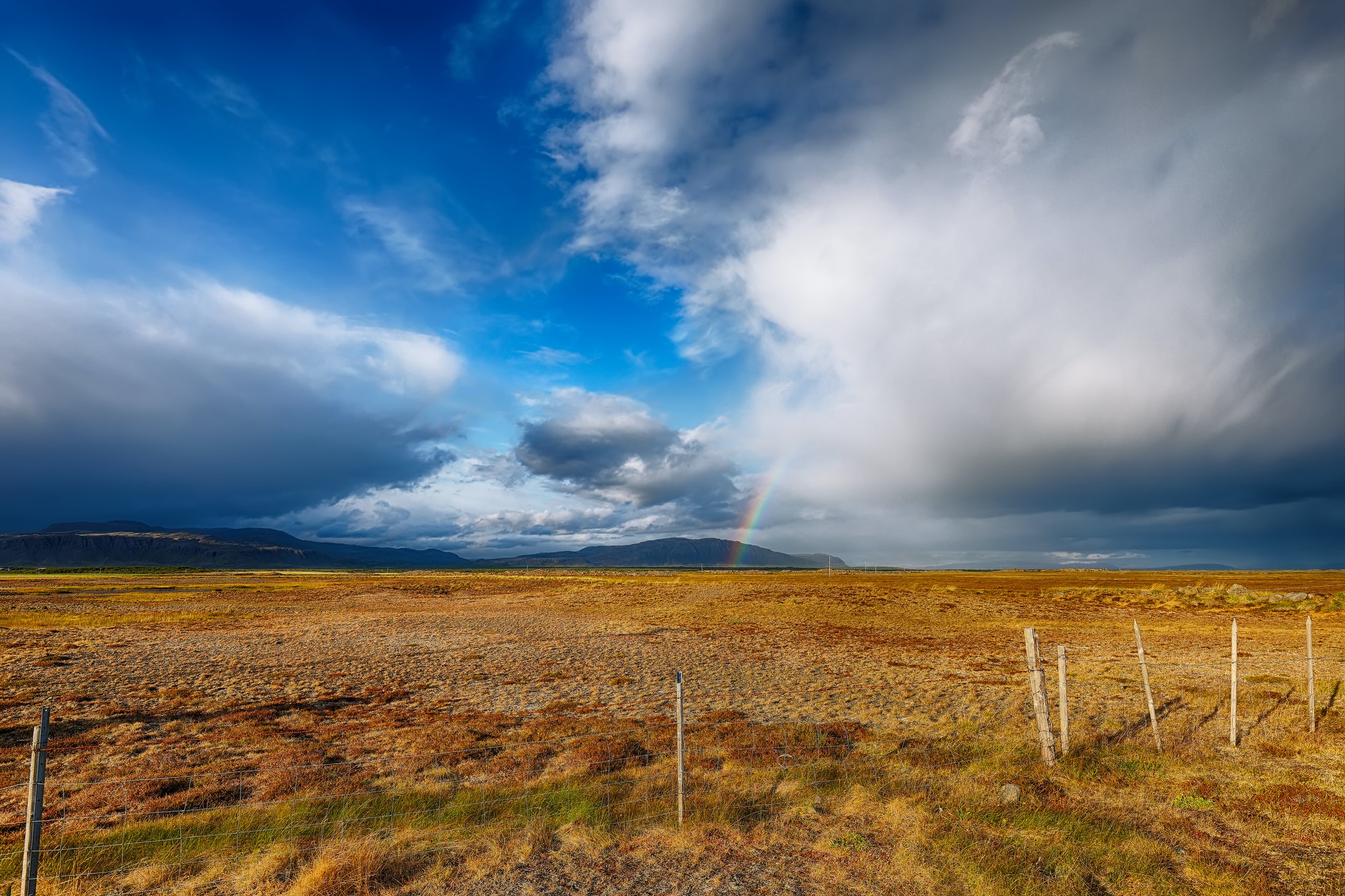Gorgeous Icelandic stormy landscape with rainbow.